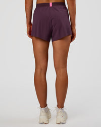 Woman wearing Accelerate 3" High-Rise Running Short - Midnight Plum-Sugar Plum | Set:true | Angle:back | Model:Emelia | Size:S | Thumbnail Index: 4
