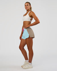 Woman wearing Accelerate 3" High-Rise Running Short - Taupe Ash-Glacial Blue | Model:Emelia | Size:S | Thumbnail Index: 6