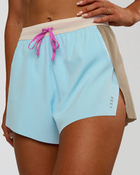 Woman wearing Accelerate 3" High-Rise Running Short - Taupe Ash-Glacial Blue | Model:Emelia | Size:S | Thumbnail Index: 4
