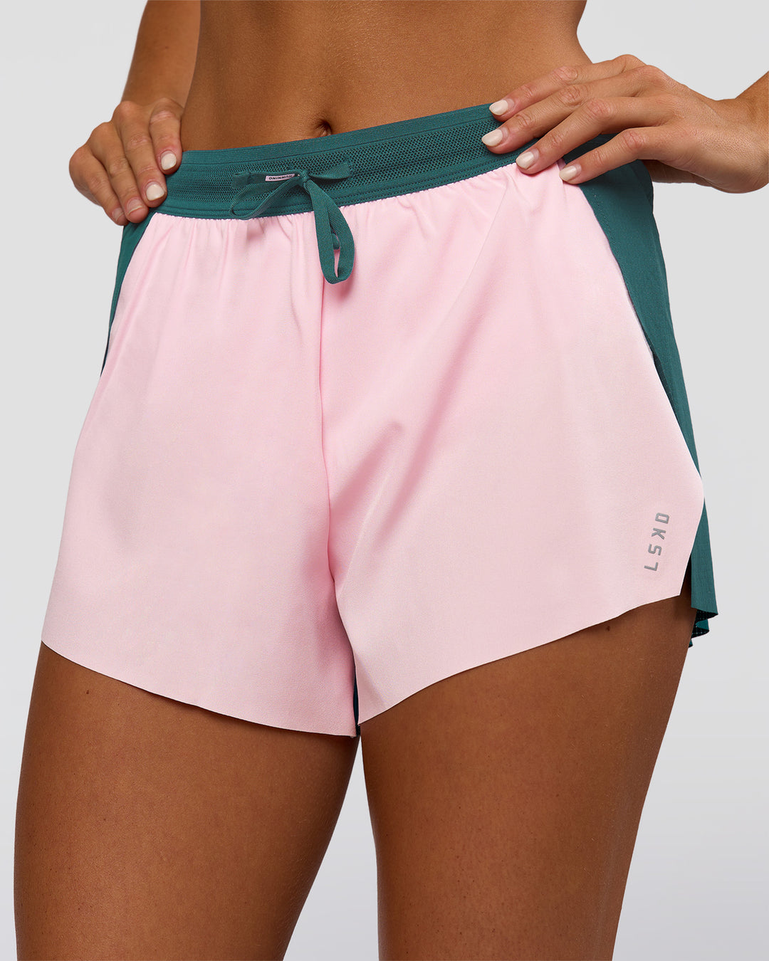 Woman wearing Accelerate 3" High-Rise Running Short - Transformative Teal-Marshmallow | Set:true | Angle:closeup | Model:Amity | Size:S - view 5