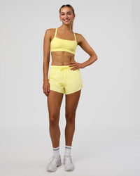 Woman wearing Accelerate 3" High-Rise Running Short - Yellow Fizz | Model:Evie | Size:S | Thumbnail Index: 2