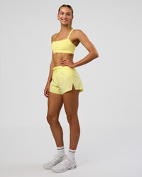 Woman wearing Accelerate 3" High-Rise Running Short - Yellow Fizz | Model:Evie | Size:S | Thumbnail Index: 4