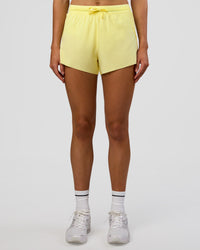 Woman wearing Accelerate 3" High-Rise Running Short - Yellow Fizz | Set:true | Angle:front | Model:Evie | Size:S | Thumbnail Index: 1