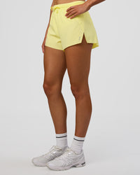Woman wearing Accelerate 3" High-Rise Running Short - Yellow Fizz | Set:true | Angle:side | Model:Evie | Size:S | Thumbnail Index: 6