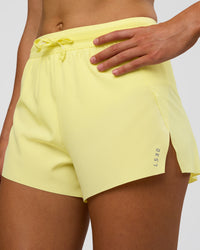 Woman wearing Accelerate 3" High-Rise Running Short - Yellow Fizz | Set:true | Angle:closeup | Model:Evie | Size:S | Thumbnail Index: 0