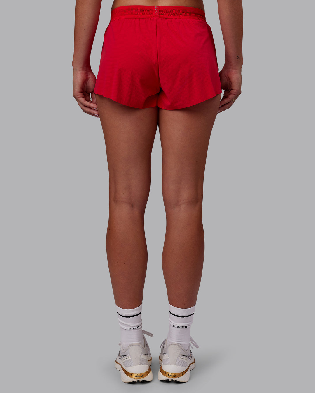 Woman wearing Accelerate Run Shorts - Scarlet | Set:true | Angle:back | Model:Charlize | Size:S - view 4