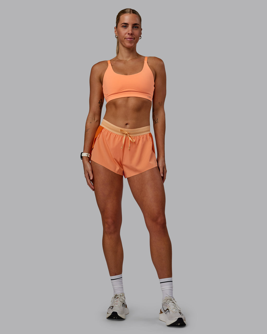 Woman wearing Accelerate 3" Run Shorts - Cantaloupe Colourblock - view 7
