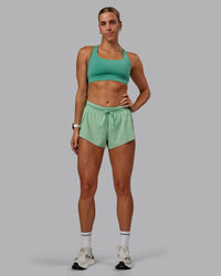 Woman wearing Accelerate 3" Run Shorts - Surreal Green | Thumbnail Index: 6
