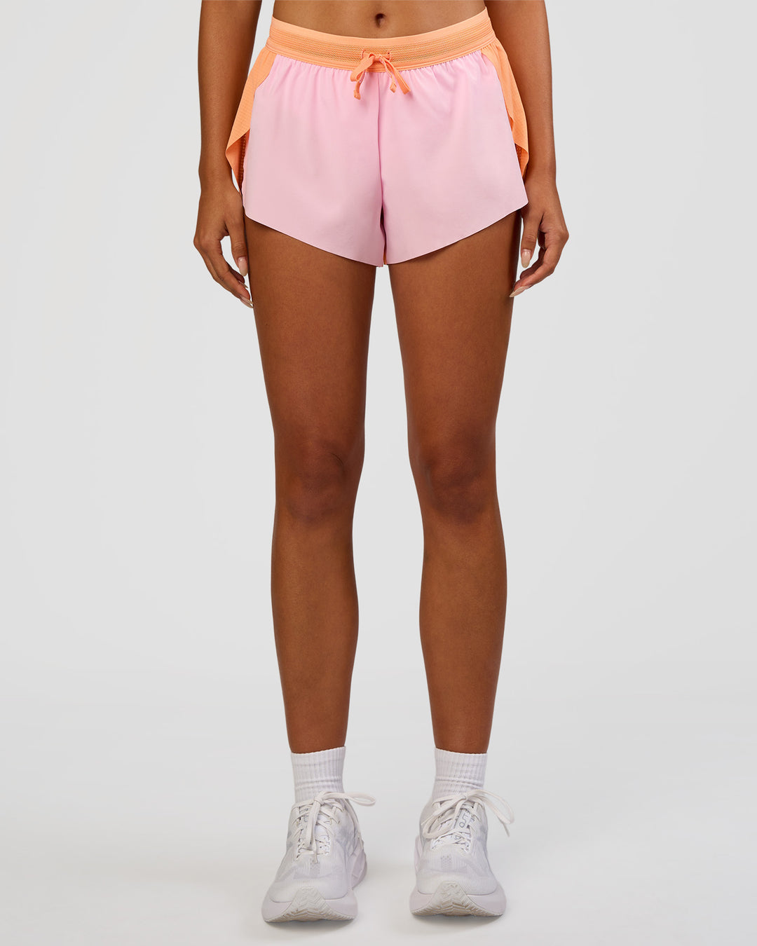 Woman wearing Accelerate 3" Mid-Rise Running Short - Cantaloupe-Marshmallow | Set:true | Angle:front | Model:Ruby | Size:S - view 8