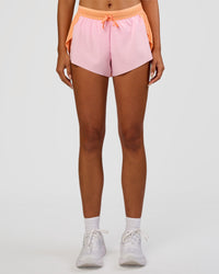 Woman wearing Accelerate 3" Mid-Rise Running Short - Cantaloupe-Marshmallow | Set:true | Angle:front | Model:Ruby | Size:S | Thumbnail Index: 7