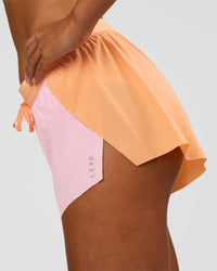 Woman wearing Accelerate 3" Mid-Rise Running Short - Cantaloupe-Marshmallow | Model:Ruby | Size:S | Thumbnail Index: 5