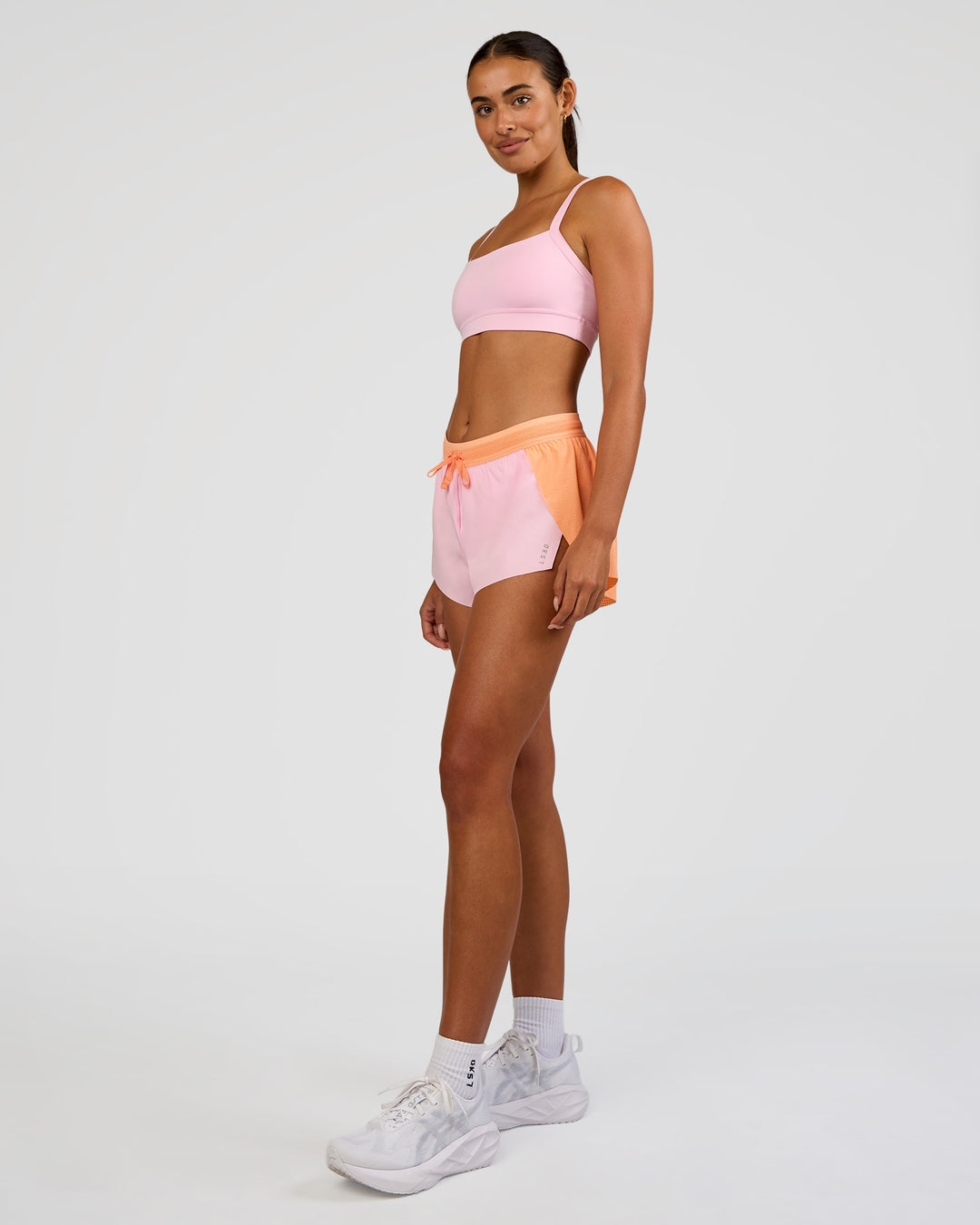Woman wearing Accelerate 3" Mid-Rise Running Short - Cantaloupe-Marshmallow | Model:Ruby | Size:S - view 7