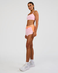 Woman wearing Accelerate 3" Mid-Rise Running Short - Cantaloupe-Marshmallow | Model:Ruby | Size:S | Thumbnail Index: 6