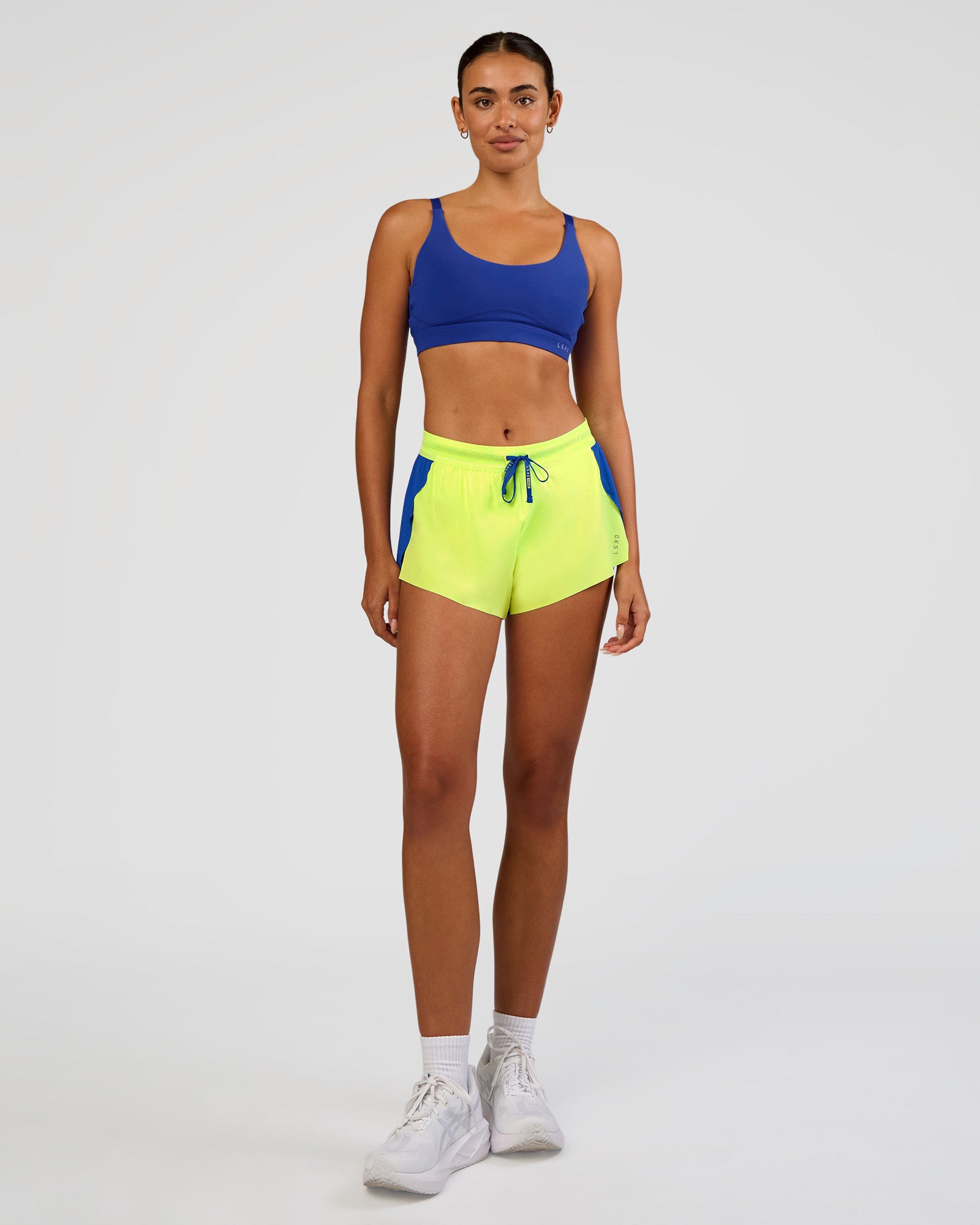 Woman wearing Accelerate 3" Mid-Rise Running Short - Electric Indigo-Lime Glo | Model:Ruby | Size:S
