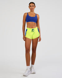 Woman wearing Accelerate 3" Mid-Rise Running Short - Electric Indigo-Lime Glo | Model:Ruby | Size:S | Thumbnail Index: 1