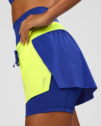 Woman wearing Accelerate 3" Mid-Rise Running Short - Electric Indigo-Lime Glo | Model:Ruby | Size:S | Thumbnail Index: 5