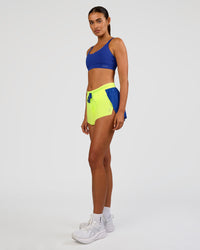 Woman wearing Accelerate 3" Mid-Rise Running Short - Electric Indigo-Lime Glo | Model:Ruby | Size:S | Thumbnail Index: 7