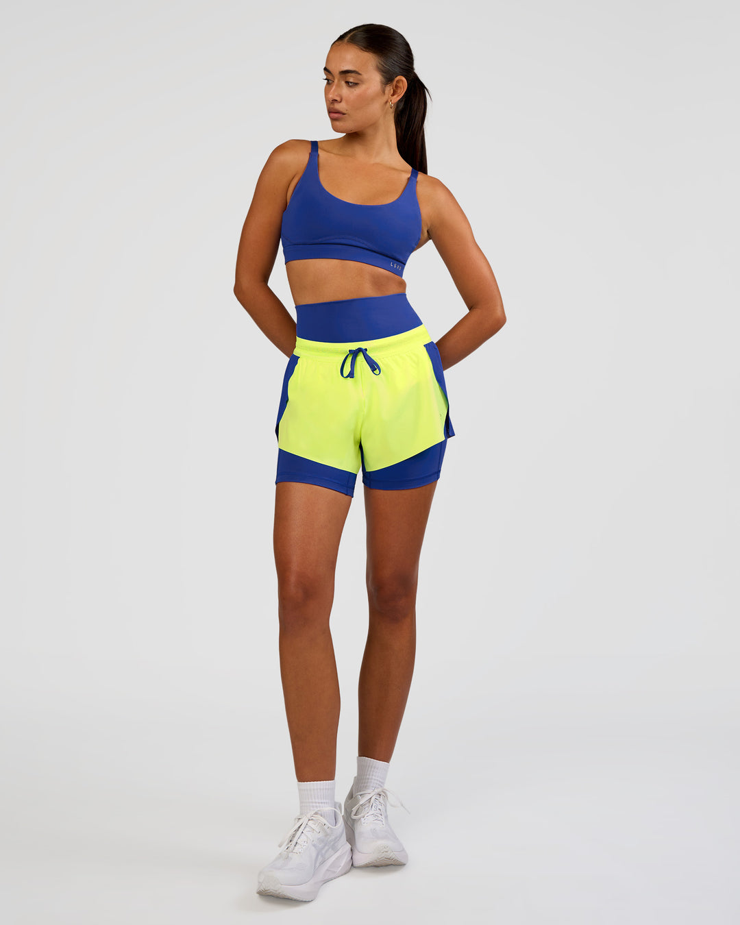 Woman wearing Accelerate 3" Mid-Rise Running Short - Electric Indigo-Lime Glo | Model:Ruby | Size:S - view 9