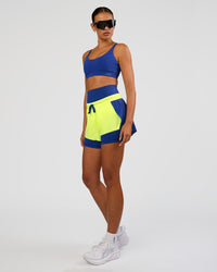 Woman wearing Accelerate 3" Mid-Rise Running Short - Electric Indigo-Lime Glo | Model:Ruby | Size:S | Thumbnail Index: 4