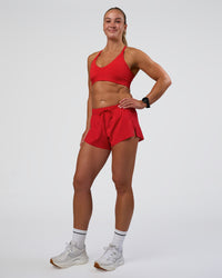 Woman wearing Accelerate 3" Mid-Rise Running Short - Flame | Model:Sav | Size:S | Thumbnail Index: 4
