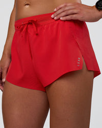 Woman wearing Accelerate 3" Mid-Rise Running Short - Flame | Set:true | Angle:closeup | Model:Sav | Size:S | Thumbnail Index: 0