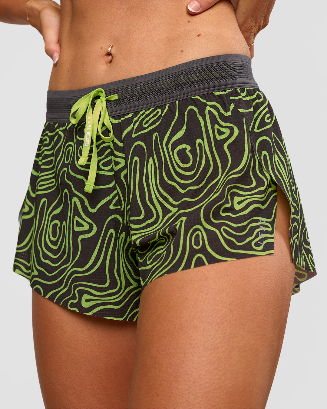 Woman wearing Accelerate 3" Mid-Rise Running Short - Friction Print Hyper Green | Set:true | Angle:closeup | Model:Emelia | Size:S - view 10