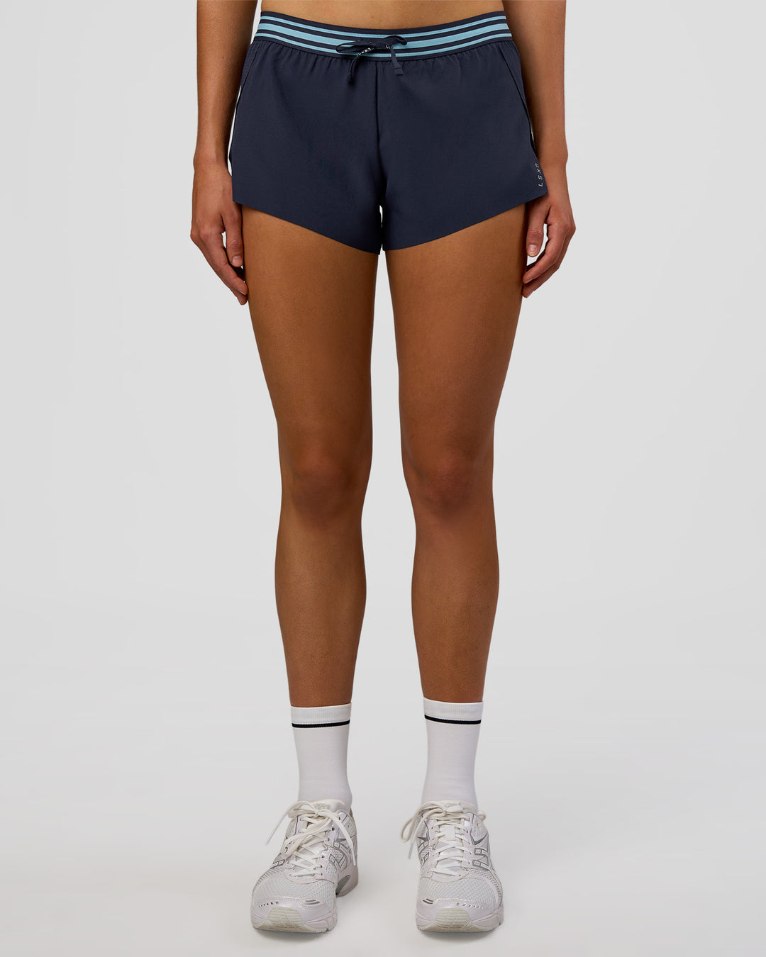 Woman wearing Accelerate 3" Mid-Rise Running Short - Future Navy-Baltic Sea | Set:true | Angle:front | Model:Evie | Size:S - view 3