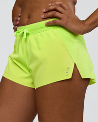 Woman wearing Accelerate 3" Mid-Rise Running Short - Hyper Green | Set:true | Angle:closeup | Model:Rosie | Size:S | Thumbnail Index: 5