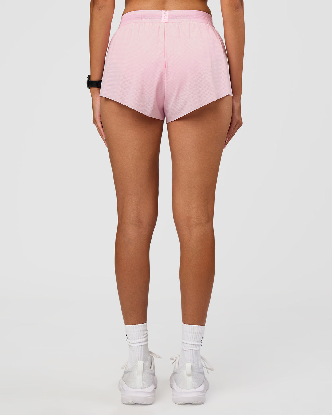 Woman wearing Accelerate 3" Mid-Rise Running Short - Marshmallow | Set:true | Angle:back | Model:Rhiley | Size:S - view 3