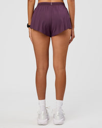 Woman wearing Accelerate 3" Mid-Rise Running Short - Midnight Plum | Set:true | Angle:back | Model:Rhiley | Size:S | Thumbnail Index: 2