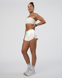 Woman wearing Accelerate 3" Mid-Rise Running Short - Off White-Floral Sticker | Model:Abbey | Size:S | Thumbnail Index: 0