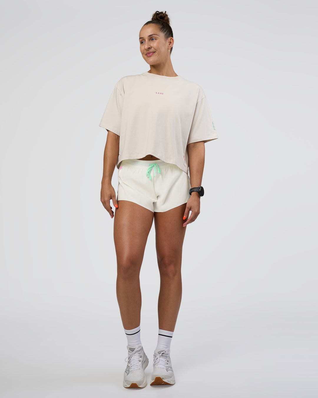 Woman wearing Accelerate 3" Mid-Rise Running Short - Off White-Floral Sticker | Model:Abbey | Size:S - view 8