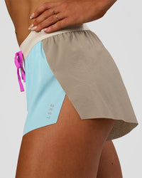 Woman wearing Accelerate 3" Mid-Rise Running Short - Taupe Ash-Glacial Blue | Set:true | Angle:closeup | Model:Emelia | Size:S | Thumbnail Index: 4