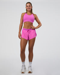 Woman wearing Accelerate 3" Mid-Rise Running Short - Ultra Fuchsia | Model:Amity | Size:S | Thumbnail Index: 1