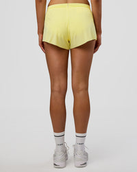 Woman wearing Accelerate 3" Mid-Rise Running Short - Yellow Fizz | Set:true | Angle:back | Model:Evie | Size:S | Thumbnail Index: 2