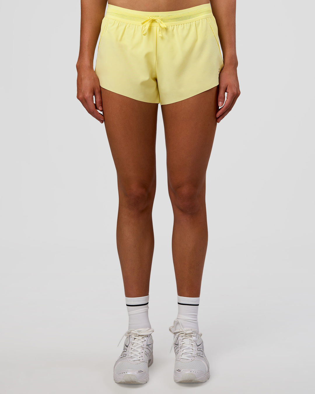 Woman wearing Accelerate 3" Mid-Rise Running Short - Yellow Fizz | Set:true | Angle:front | Model:Evie | Size:S - view 2