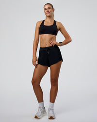 Woman wearing Accelerate 3" Pleated Mid-Rise Running Short - Black | Model:Emelia | Size:S | Thumbnail Index: 9