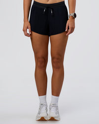 Woman wearing Accelerate 3" Pleated Mid-Rise Running Short - Black  | Set:true | Angle:front | Model:Emelia | Size:S | Thumbnail Index: 8