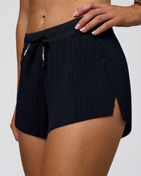 Woman wearing Accelerate 3" Pleated Mid-Rise Running Short - Black | Model:Emelia | Size:S | Thumbnail Index: 6