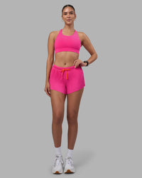 Woman wearing Accelerate 3" Pleated Running Short - Ultra Pink | Model:Rhiley | Size:S | Thumbnail Index: 4