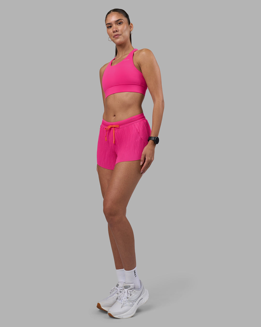 Woman wearing Accelerate 3" Pleated Running Short - Ultra Pink | Model:Rhiley | Size:S - view 11