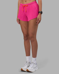 Woman wearing Accelerate 3" Pleated Running Short - Ultra Pink | Model:Rhiley | Size:S | Thumbnail Index: 12