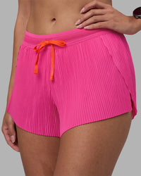 Woman wearing Accelerate 3" Pleated Running Short - Ultra Pink | Model:Rhiley | Size:S | Thumbnail Index: 1