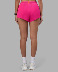 Woman wearing Accelerate 3" Pleated Running Short - Ultra Pink | Model:Rhiley | Size:S | Thumbnail Index: 6