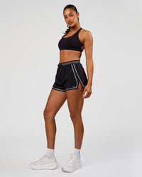 Woman wearing Accelerate 3" Reflective High-Rise Running Short - Black-Reflective | Model:Rosie | Size:S | Thumbnail Index: 6