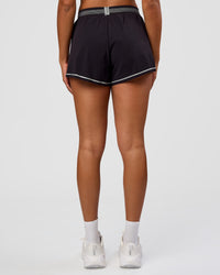 Woman wearing Accelerate 3" Reflective High-Rise Running Short - Black-Reflective | Set:true | Angle:back | Model:Rosie | Size:S | Thumbnail Index: 3