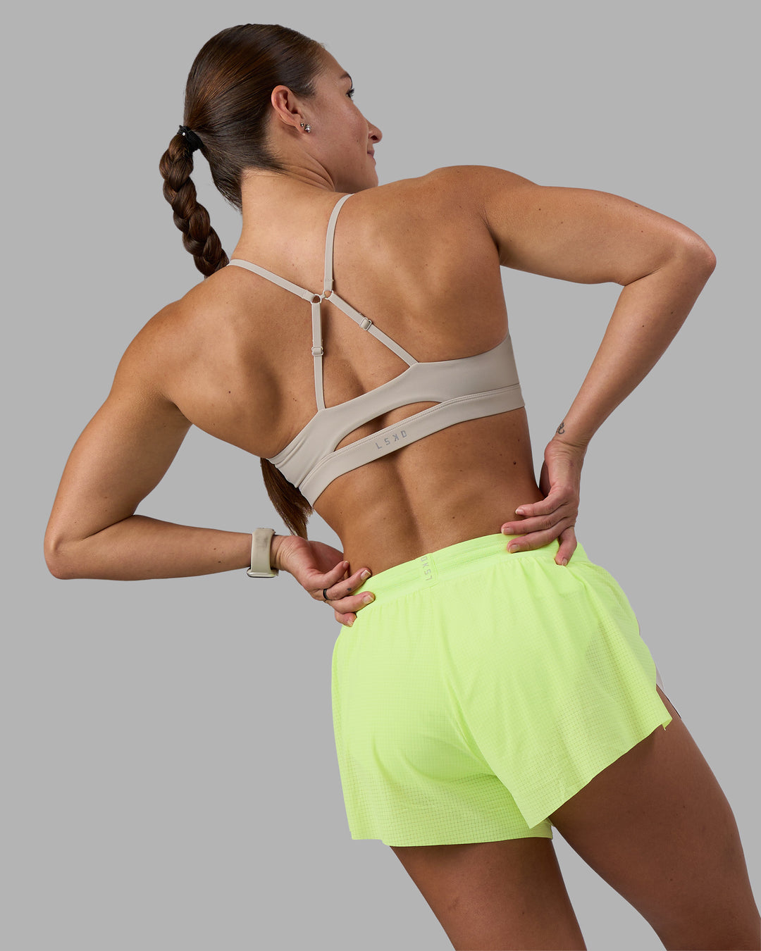 Woman wearing Accelerate 3" Running Short - Lime Glo-Shale Beige | Model:Hannah | Size:S - view 9