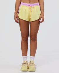Woman wearing Accelerate 3" Mid-Rise Running Short - Marshmallow-Lemon | Set:true | Angle:front | Model:Grace | Size:S | Thumbnail Index: 6