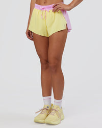 Woman wearing Accelerate 3" Mid-Rise Running Short - Marshmallow-Lemon | Set:true | Angle:side | Model:Grace | Size:S | Thumbnail Index: 4