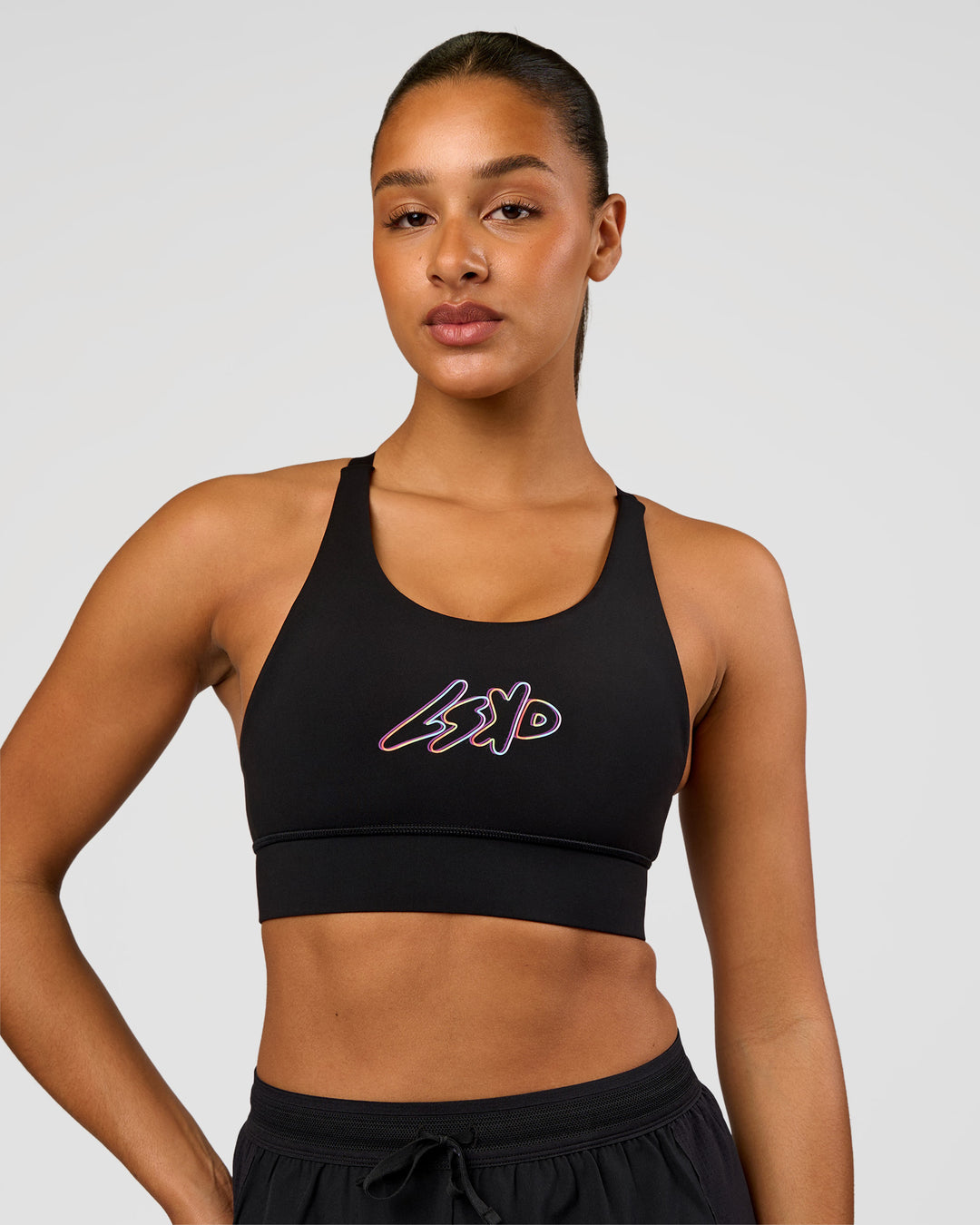 Woman wearing Accelerate Graphic Sports Bra - Black-Radiate | Model:Rosie | Size:S - view 3